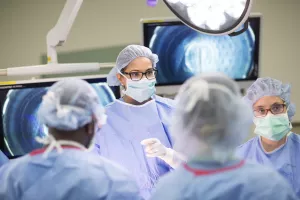 Sajani Shah, MD (Chief of Bariatric Surgery at Tufts Medical Center) performing bariatric surgery with help of a team.