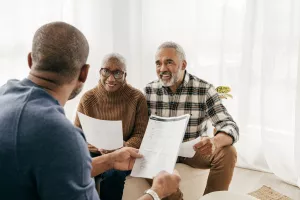A couple meets with financial advisor to go over their estate planning documents.