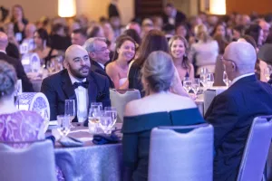 A room full of people in formal clothes at a fundraising gala for Lowell General Hospital