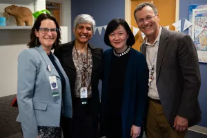 Doctors, investigators and staff pose with smiles