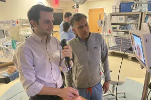 Pulmonary and critical care fellows at a machine