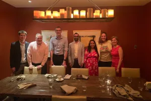 A group of people smiling at a table