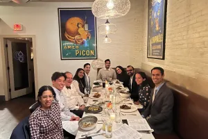 A group of people smiling at a table