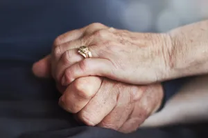 Elderly couple holding hands