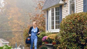 Angela Briggette, LPN walks outside of patient's home after having a care at home appointment.
