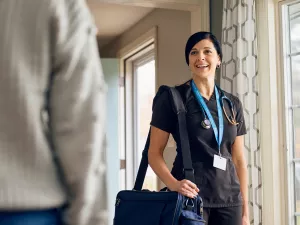 Care at Home's Rebecca Clementi, RN greets patient in their home during appointment.