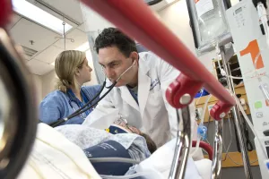 Anna Murphy, RN, Kaitlyn Dimmel, PA and Matthew Mostofi, DO, Assistant Chief of Emergency Medicine, help patient in the Emergency Room at Tufts Medical Center. 