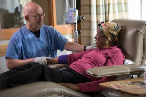 A doctor helping a woman on an IV