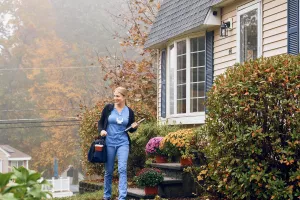 Angela Briggette, LPN walks outside of patient's home after having a care at home appointment.